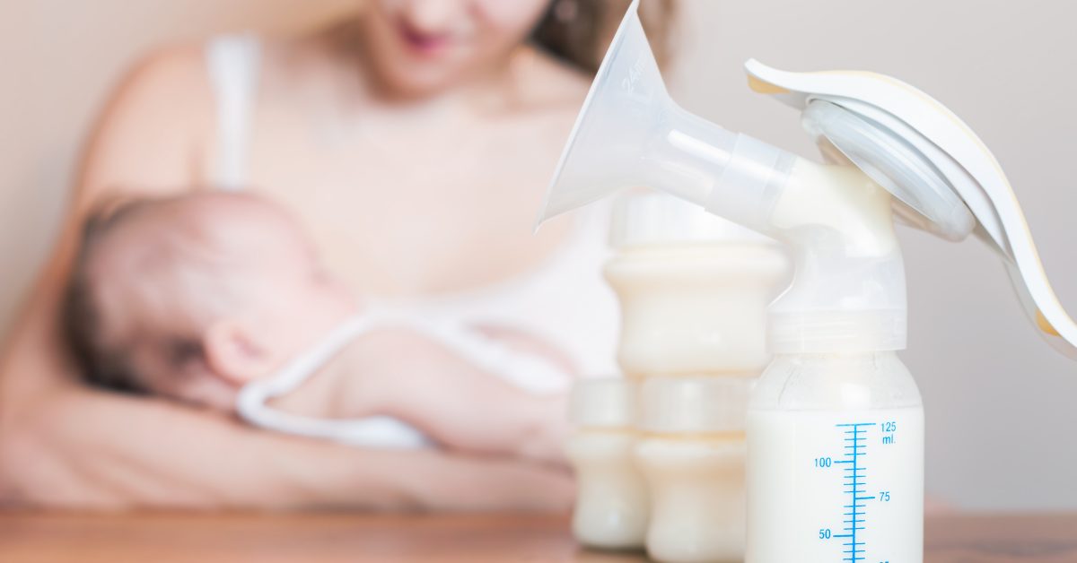 Manual breast pump and mother feeding at background, mothers breast milk is the most healthy food for newborn baby